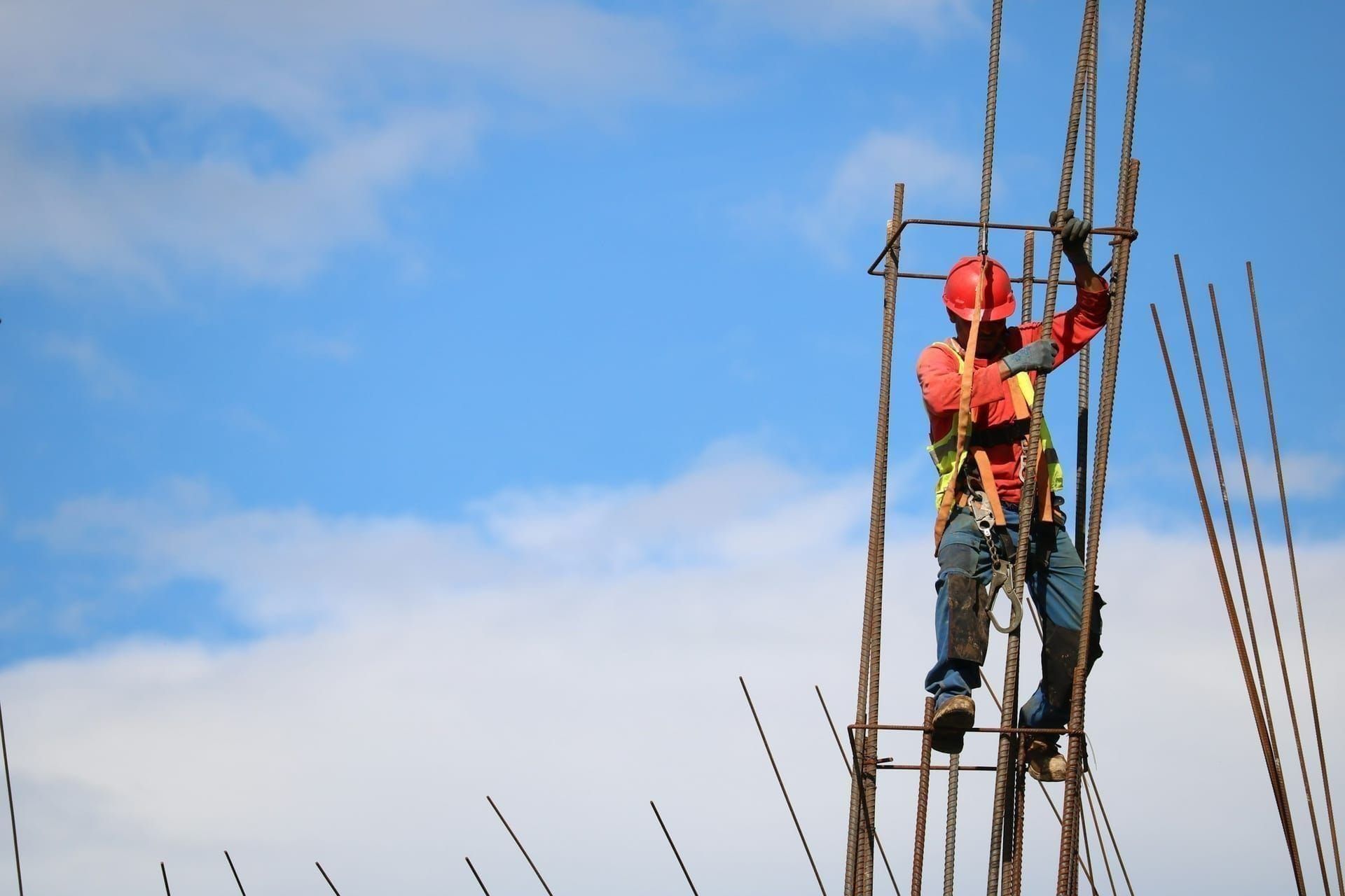 Steel fixer working at height on a reinforcement cage